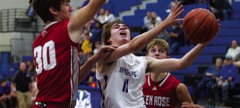 Jax Pratus fights through contact to finish at the rim against Glen Rose during the Badgers’ game. HUNTER KING | DISPATCH RECORD