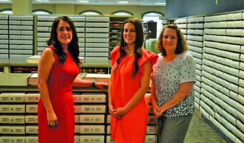 Lampasas County Clerk Dianne Miller and her staff members Dallas Munoz and Dawn Rodman, left to right, stand in a storage room that contains hard copies of county land records. On June 10, these books of property records such as deeds, judgments and tax liens will be taken to a Dallas imaging facility to be digitized. ERICK MITCHELL | DISPATCH REACORD