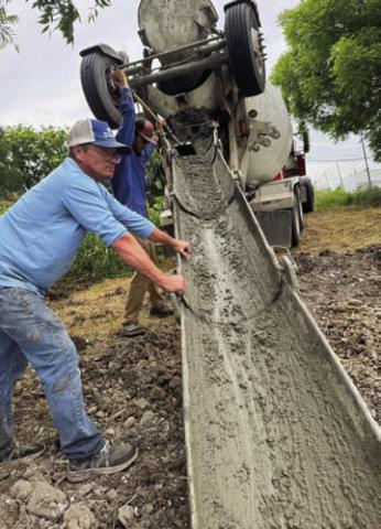 RKJ Construction employees prepare to pour cement for the bridge support footings. Rex Johnson of RKJ Construction and his late wife were donors of the land that has become Cooper Spring Nature Park. COURTESY PHOTO