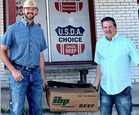 Courtesy photo Lampasas County Farm Bureau President Heston McBride, left, visits with new Farm Bureau member Daryl Raub, who picked up his Family Meat Pack, valued at $250, from M&amp;M Butcher Block.