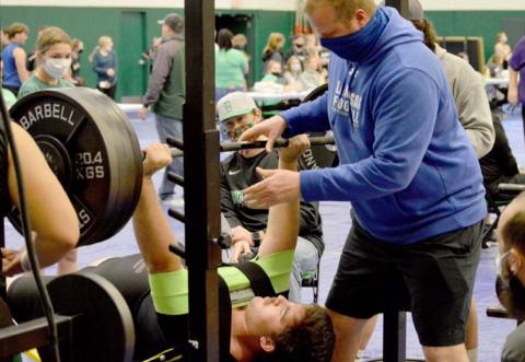 John Long improved his school records in the 308-pound weight class at Burnet. Assistant coach Heath Naragon spots for him. JEFF LOWE | DISPATCH RECORD
