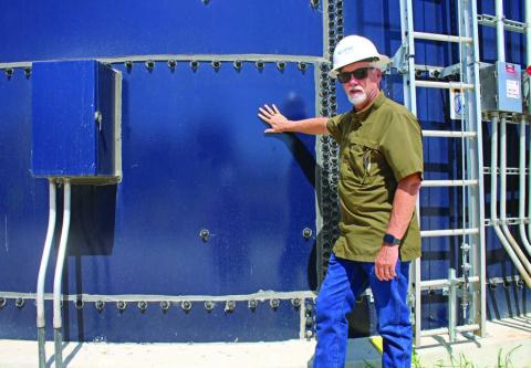 Darrin Barker highlights the use of Corix’s “clear well,” a glass-insulated container that stores clean, filtered water at the plant. MASON HINES | DISPATCH RECORD