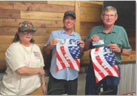 courtesy photo 42 Tournament coordinator Darlene Johnson presents banners and prize winnings to the top team, David Standefer, in center, and Neal Leavell.