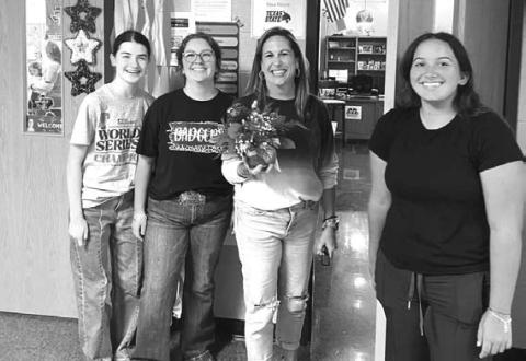 COURTESY PHOTO From left are Kellyn Ramsour, Michaela White, LHS staff member Shea Moyer and Natalie Gresko delivering flowers to those who have signed up for Flower of the Month.