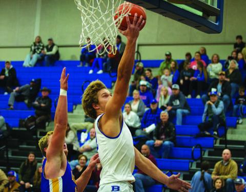 Haegan Oncken lays a ball off the backboard for two points on the fast break against Blanco. HUNTER KING | DISPATCH RECORD