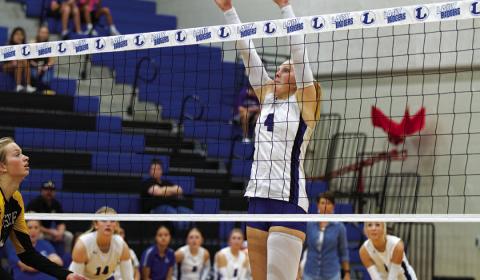 Brylie Turner leaps for a block during Tuesday’s match against the Lady Hornets. She also led the team in kills. HUNTER KING | DISPATCH RECORD