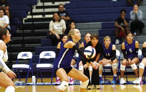 HUNTER KING | DISPATCH RECORD Brailey Wilson makes a pass as head coach Christy Wiley watches on from the bench.