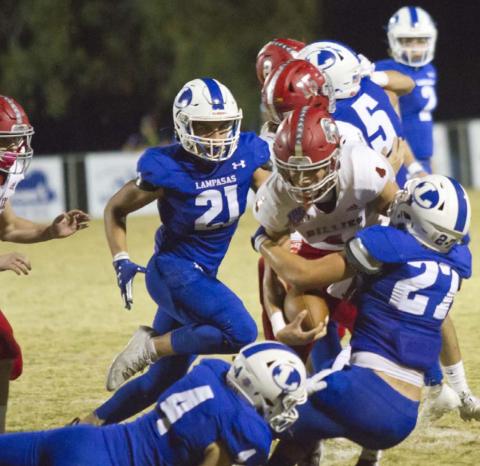 Peyton Underwood (4), Aden Rascoe (27) and Ethan Moreno (21) make a tackle in the last regularseason game on Friday at Badger Field. JEFF LOWE | DISPATCH RECORD