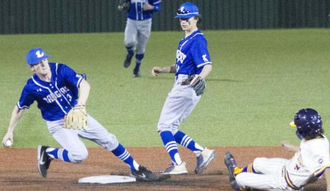 Badger shortstop Carson Bekker, far left, forces an out at second base just ahead of a sliding base runner. JEFF LOWE | DISPATCH RECORD