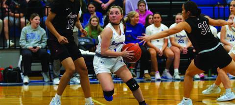 Abra White drives past Austin High defenders for two points during Tuesday night’s game. HUNTER KING | DISPATCH RECORD
