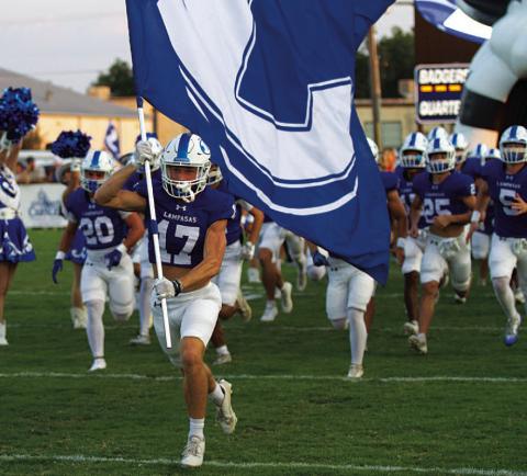 HUNTER KING | DISPATCH RECORD Sean Smith leads the Badgers onto the field before every game.