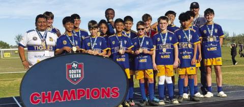 COURTESY PHOTO | MIGUEL ACOSTA The Lampasas Tigres pose with their championship medals after winning in San Antonio.