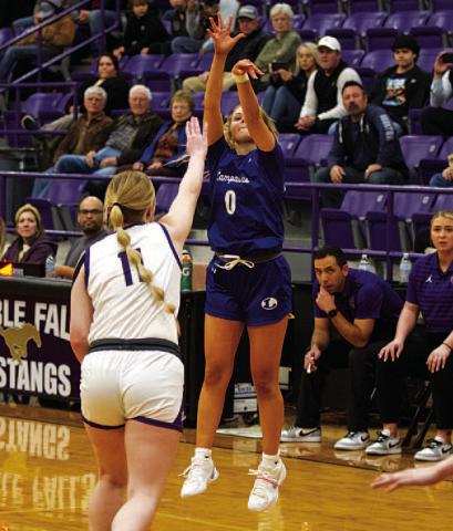 HUNTER KING | DISPATCH RECORD Addison Borchardt shoots a three-point shot over a reaching defender.
