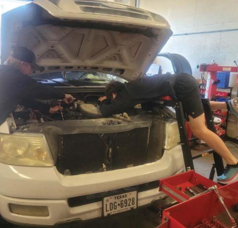 Lampasas High School Auto Tech II students Chris Vincent, left, and Nathan Abken are shown working on a pickup. The Hoffpauir dealership has partnered with the school district to offer students training in various aspects of the automotive repair industry. COURTESY PHOTO