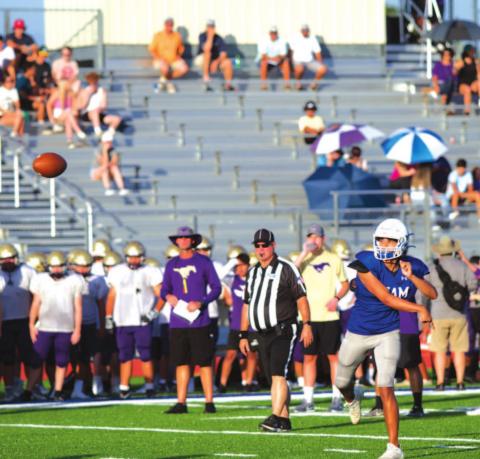 Dylan Sanchez throws a pass during a scrimmage against Marble Falls at the beginning of last season. The Badgers and Mustangs will compete in District 13-4A in the fall. FILE PHOTO