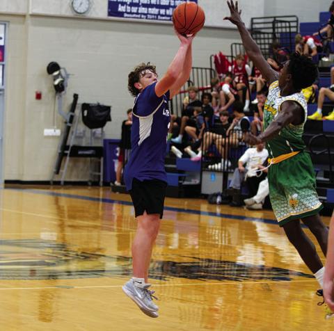 Aidan Nuckles shoots over the outstretched hand of a defender. HUNTER KING | DISPATCH RECORD