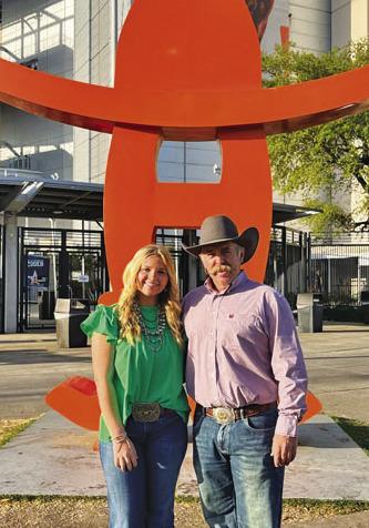 Kari Greiner is shown with her father, Corey, at a major show. Greiner competed in San Antonio, Houston and Fort Worth in each of the three years she showed animals. COURTESY PHOTO