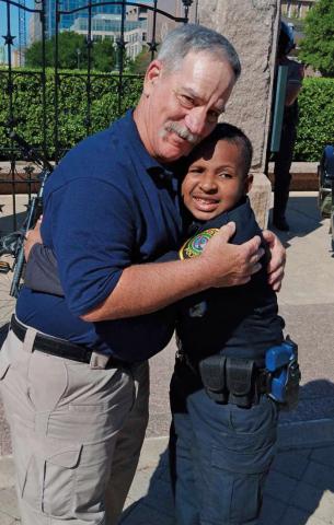 Paul Miceli embraces Devarjaye “DJ” Daniel at Daniel’s honorary swearing-in at the Texas Capitol. erick mitchell | dispatch Record
