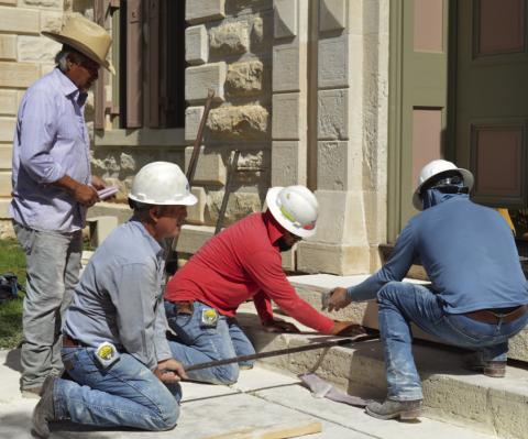 Flint Hughes and his masonry crew work to replace a threshold stone at the Lampasas County Courthouse. Renovation on the historic structure extended through most of 2025. FILE PHOTO