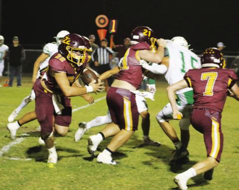 Lukas Smailus-Cruz looks for running room while Roy Carr (21) and Easton Hamilton (7) block. Smailus-Cruz rushed for three touchdowns in the game. MASON HINES | DISPATCH RECORD