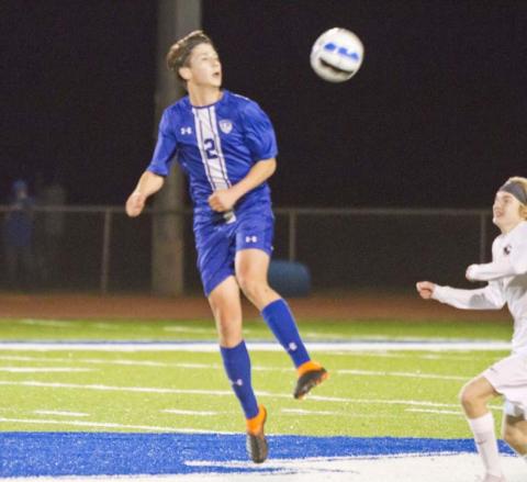 Cody Woods plays the ball at midfield in a recent district match. JEFF LOWE | DISPATCH RECORD