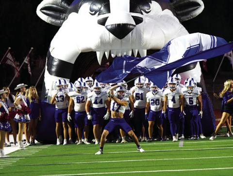 Sean Smith waves the flag ahead of the Badgers’ game against Brownwood last Friday.