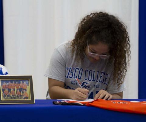 Alycia Cantu signs her letter of intent to play softball for Cisco College at the Lampasas High School gym on Wednesday. HUNTER KING | DISPATCH RECORD