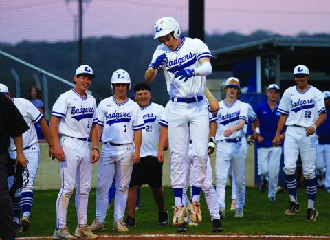 Jonas Andersen hops onto home plate after launching a two-run home run to open the scoring in last week’s game. HUNTER KING | DISPATCH RECORD
