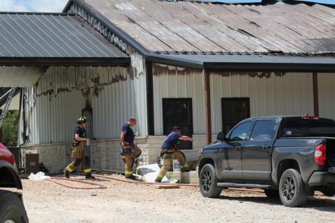 Crews remained on the scene of a house fire Wednesday on County Road 3064 after the flames were extinguished. The homeowner was in the house at the time of the fire and escaped without injuries. Joycesarah McCabe | Dispatch Record