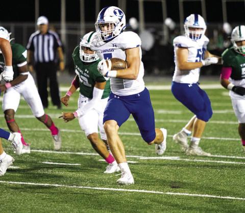 Jett Walker breaks through the Taylor defense on one of his four touchdowns last Friday. HUNTER KING | DISPATCH RECORD