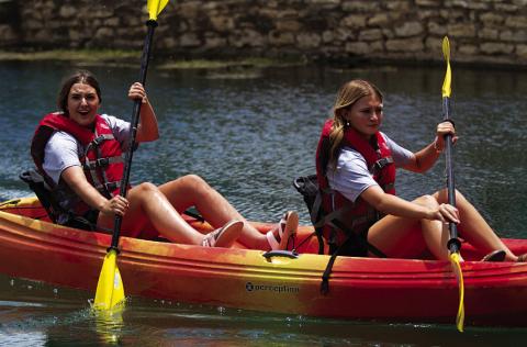 Sagen Plouff and Pacey Underwood paddle down the creek during the youth tandem race last Saturday. HUNTER KING | DISPATCH RECORD
