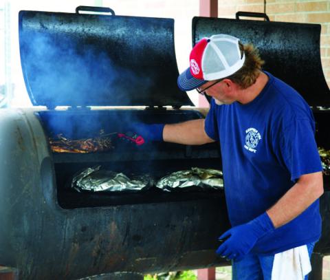 Kempner Volunteer Fire Department Capt. Todd Burkett smokes brisket to the perfect temperature during last year’s event. This year’s BBQ and Auction Fundraiser is set for April 18. FILE PHOTO