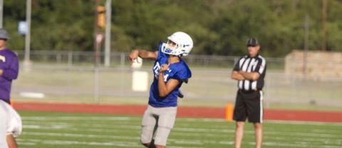 Badger quarterback Dylan Sanchez launches a ball deep into the air looking for a receiver downfield during the first scrimmage against Marble Falls. HUNTER KING | DISPATCH RECORD