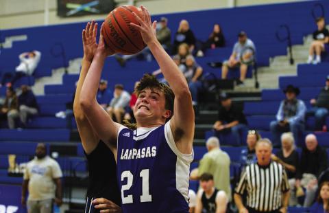 Sam Williams goes up against contact for a layup against Robinson on Tuesday. HUNTER KING | DISPATCH RECORD