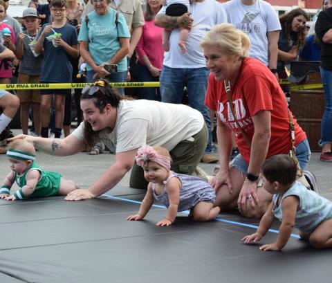 Families from across the county bring their crawlers and toddlers to participate in the Diaper Derby, held on the Lampasas courthouse square. One parent often is stationed at the starting line, while another family member awaits at the finish, coaxing the child across the mat. FILE PHOTO