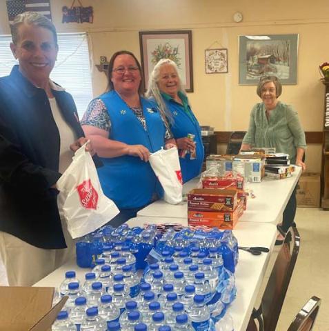 Salvation Army volunteers work with Walmart employees to prepare snack bags for first responders who were on call during the total solar eclipse. courtesy photo
