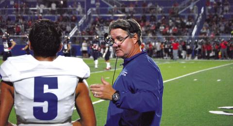 HUNTER KING | DISPATCH RECORD Head coach Troy Rogers coaches his quarterback David Flores in the second half of the East View game last Friday.