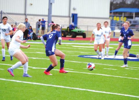 Cobie Chandler makes a pass to a teammate during the Lady Badgers’ win Tuesday night against Academy. HUNTER KING | DISPATCH RECORD