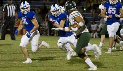 Case Brister, left, and Carson Bekker pursue a Canyon Lake ball carrier during last week’s game. HUNTER KING | DISPATCH RECORD