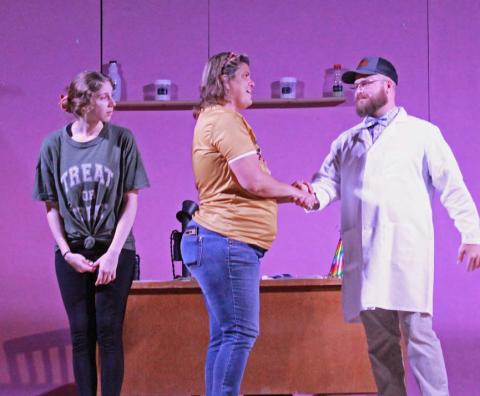 Abigail Stewart, who plays the receptionist in “The Devious Dentist …,” watches as Jennifer Wisian, in the role of nurse, greets Travis Walls, who portrays one of the two dentists in the production. Both Stewart and Wisian are from Lometa, while Walls is a Goldthwaite resident. COURTESY PHOTO