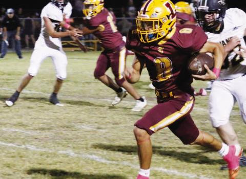MASON HINES | DISPATCH RECORD Senior Brandon Moore looks for room to accelerate during one of his two touchdown runs in Friday’s 60-14 win over Evant.
