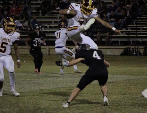 Alonso Caso hurdles over an Evant defender during the Hornets’ dominant win last week. JESSICA MALDONADO | DISPATCH RECORD