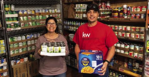 Kenny Murray of Keller Williams Real Estate joined forces with the Alycia Hooper Real Estate team on their second annual community food drive. The group collected and donated 1,473 pounds of food to St. Mary’s Catholic Church Food Pantry. Pictured are pantry volunteer Beth James and Kenny Murray, left to right. COURTESY PHOTO