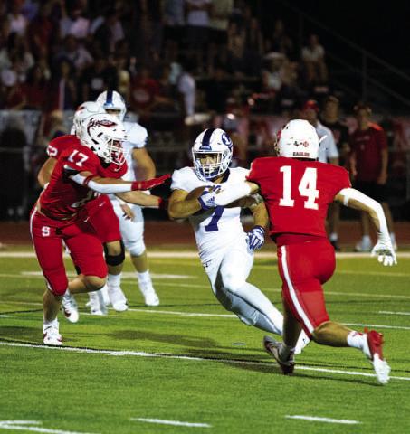 HUNTER KING | DISPATCH RECORD Daemian Rivas splits two Salado defenders. The senior ran for 144 yards last Friday night.