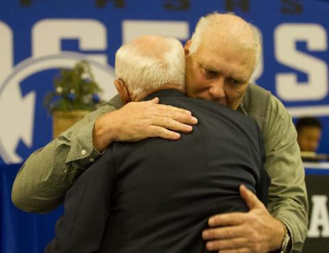 Curtis Thrift, a former Lampasas Badger standout hugs his former coach Ken Wiginton after speaking on him during his Hall of Fame induction at the 2021 Badger Football Banquet last Monday. HUNTER KING | DISPATCH RECORD