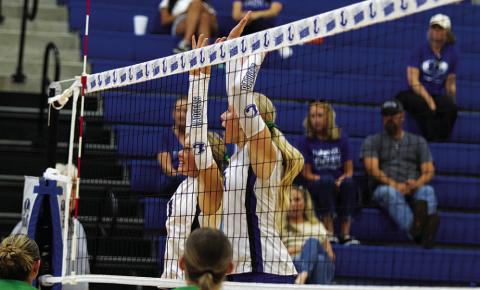 Scout Barton, left, and Brylie Turner jump for a block in their match against Burnet. HUNTER KING | DISPATCH RECORD