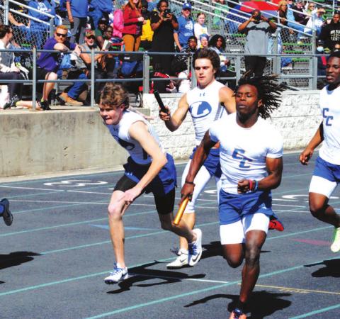 Aden Rascoe passes the baton to Nate Borchardt during the Badgers’ 4x200 meter relay race last Thursday. HUNTER KING | DISPATCH RECORD