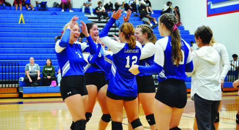 The Lady Badgers celebrate after Temple called a timeout during Tuesday’s match on the road.