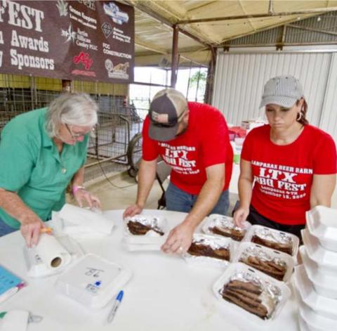 Judy Keeney, at left, Zach Taylor and Brandi Watkins sort trays of brisket for judging at the 2020 LTX BBQ. This year’s festival is an International Barbecue Cookers Association-sanctioned event, and teams can compete in a variety of categories. FILE PHOTO