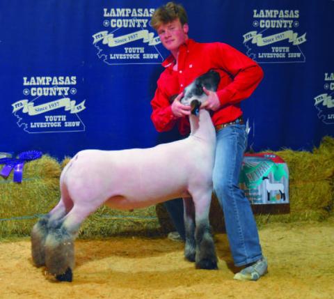 Cayhil Isom claimed grand champion honors with his heavyweight medium wool lamb. ERICK MITCHELL | DISPATCH RECORD